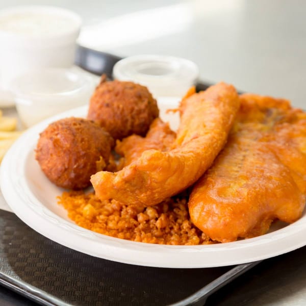 A Druther's Restaurant plate with fried fish, hush puppies, and rice, with dipping sauces.